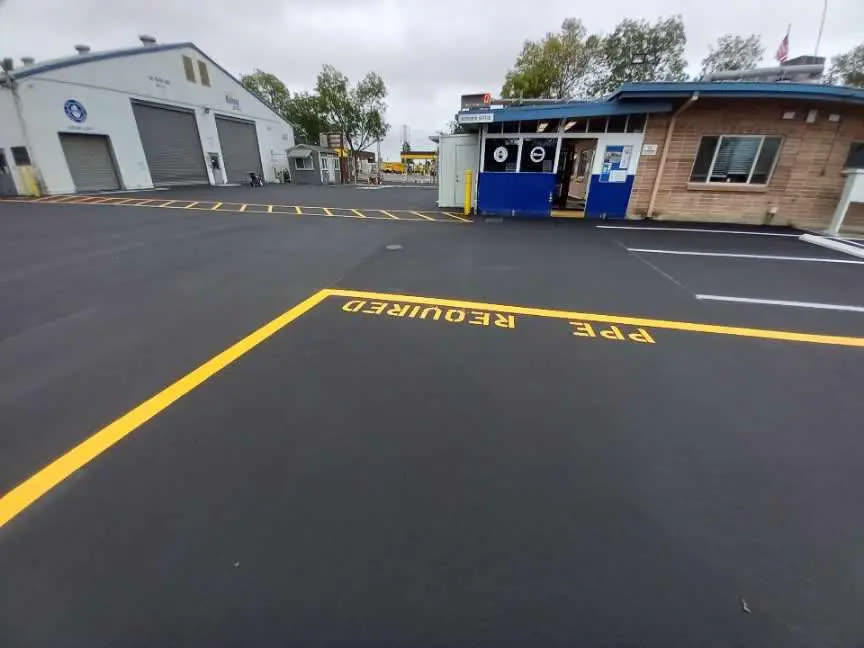 Freshly sealcoated commercial yard with new yellow markings
